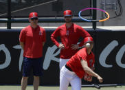 Los Angeles Angels' Shohei Ohtani, right, throws as pitching coach Doug White on in the bullpen before a baseball game against the Cincinnati Reds in Anaheim, Calif., Wednesday, June 26, 2019. Ohtani threw off a mound for the first time since Tommy John surgery Oct 1, 2018. (AP Photo/Chris Carlson)