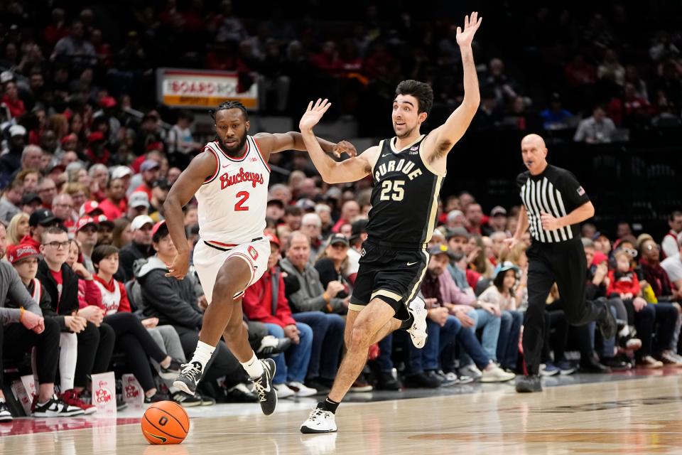 Feb 18, 2024; Columbus, Ohio, USA; Ohio State Buckeyes guard Bruce Thornton (2) and Purdue Boilermakers guard Ethan Morton (25) chase down a loose ball during the first half of the NCAA men’s basketball game at Value City Arena.