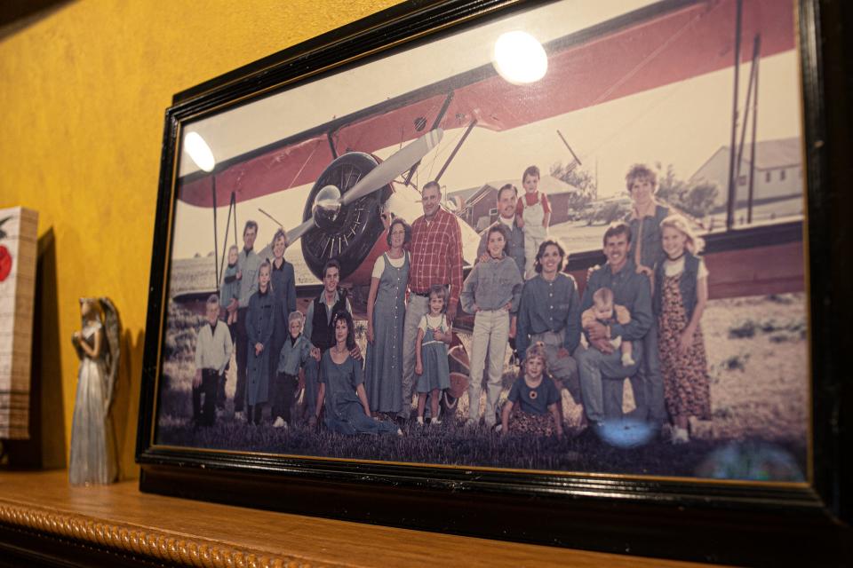 Gary VanderPol, center in red shirt, and his family pose in front of his plane in 1995.