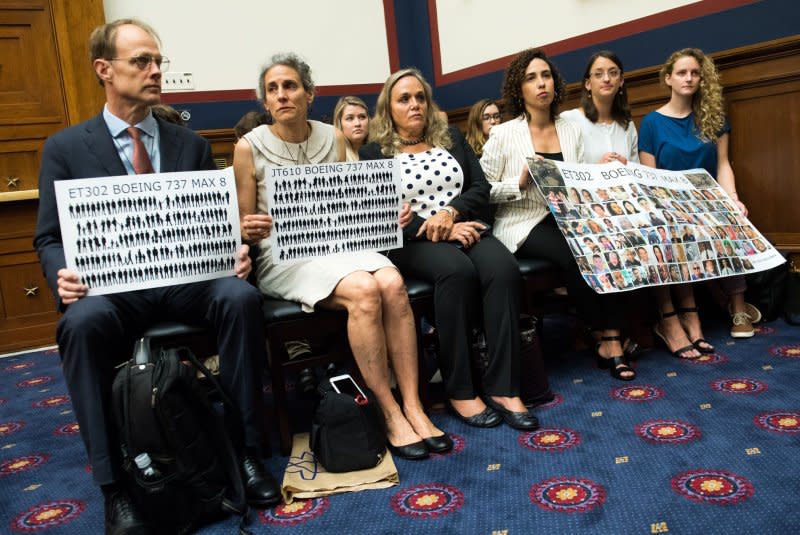 Hearing attendees hold a sign honoring the victims of the Ethiopian Airlines 302 and Lion Air Flight 610 crashes during a House Transportation Subcommittee hearing on the Boeing 737 MAX on Capitol Hill in Washington, D.C., on June 19, 2019. File Photo by Kevin Dietsch/UPI