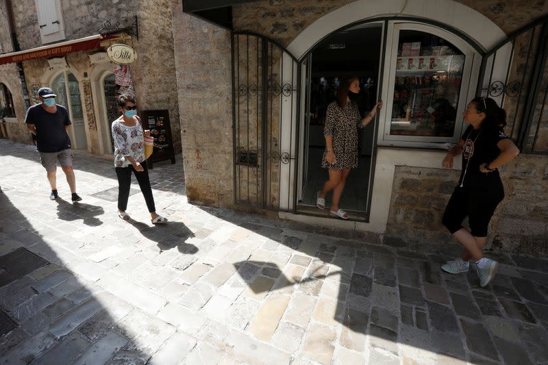 Shopkeepers wait for customers in front of a souvenir shop in the old town as coronavirus disease (COVID-19) heavily affects tourism in Budva