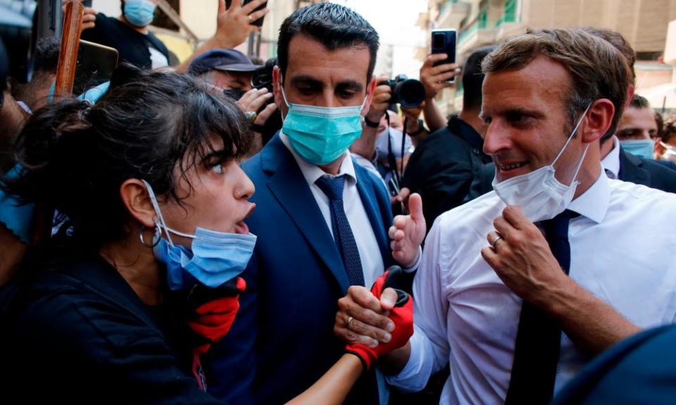 Emmanuel Macron listens to a resident on a street in Beirut on Thursday.