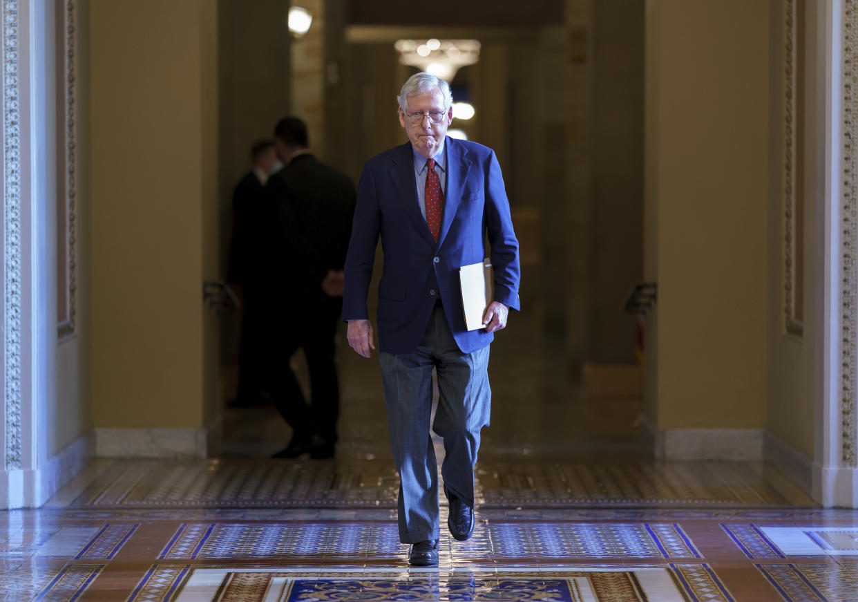 FILE - Senate Minority Leader Mitch McConnell, R-Ky., walks to the chamber for a test vote on a government spending bill, at the Capitol in Washington, Monday, Sept. 27, 2021. McConnell has been released from the hospital after treatment for a concussion and will continue to recover in an inpatient rehabilitation facility. McConnell’s office says his doctors discovered over the weekend that he had also suffered a “minor rib fracture” after he tripped and fell at the Waldorf Astoria hotel in Washington last Wednesday evening. (AP Photo/J. Scott Applewhite, File)