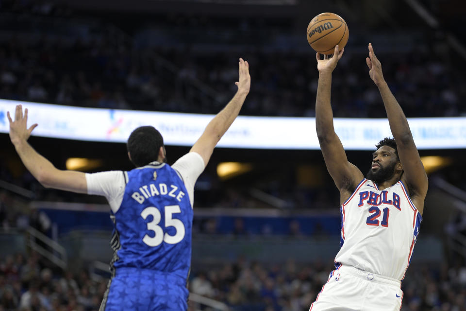 Philadelphia 76ers center Joel Embiid (21) shoots in front of Orlando Magic center Goga Bitadze (35) during the first half of an NBA basketball game, Friday, Jan. 19, 2024, in Orlando, Fla. (AP Photo/Phelan M. Ebenhack)