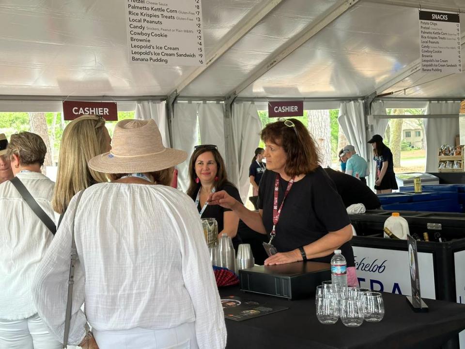 Town of Hilton Head Island FOIA compliance officer Faidra Smith (right) and paramedic Ana Piccioli greet attendees Wednesday morning at the town’s RBC Heritage concession stand.