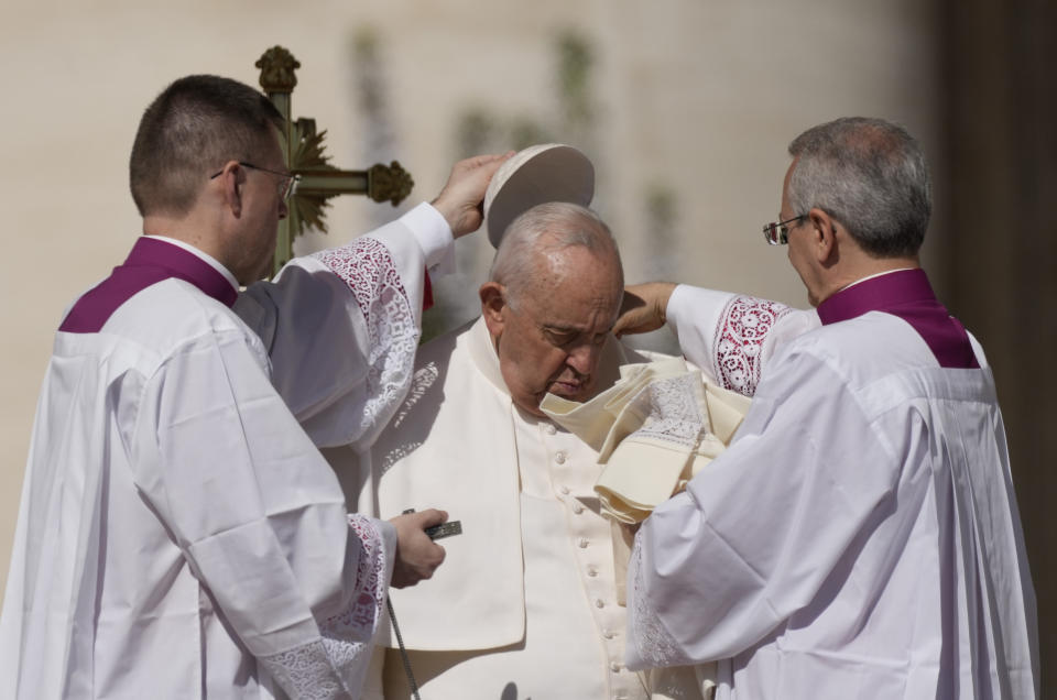 Pope Francis is helped in St. Peter's Square at The Vatican where he will celebrate the Easter Sunday mass, Sunday, April 9, 2023. (AP Photo/Alessandra Tarantino)