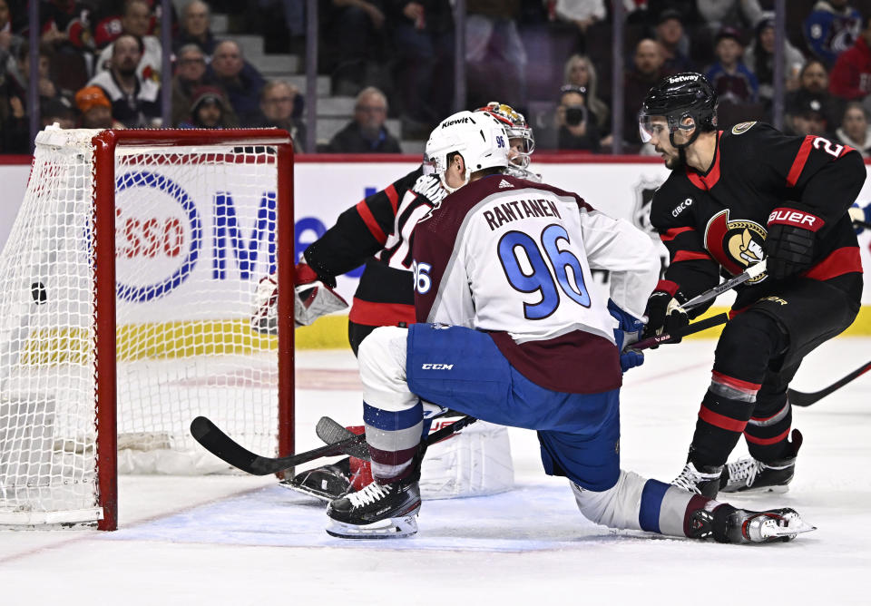 Colorado Avalanche right wing Mikko Rantanen (96) scores on Ottawa Senators goaltender Mads Sogaard (40), past defenseman Travis Hamonic (23) during the first period of an NHL hockey game, Tuesday, Jan. 16, 2024 in Ottawa, Ontario. (Justin Tang/The Canadian Press via AP)