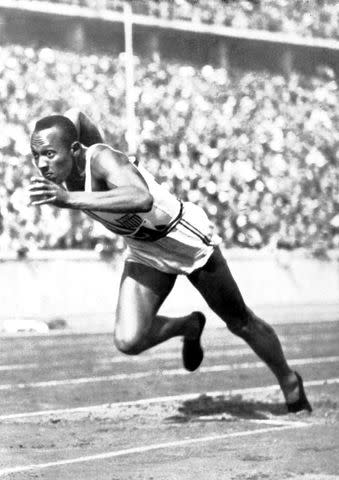 <p>Photo12/UIG/Getty</p> Jesse Owens during the Berlin Olympic Games in 1936.
