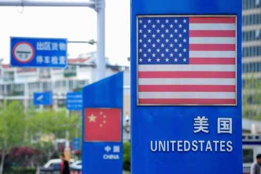 Signs with US and Chinese flags are seen in May 2019 in the Chinese port of Qingdao, where according to a US official Beijing has canceled a planned port call by a US warship