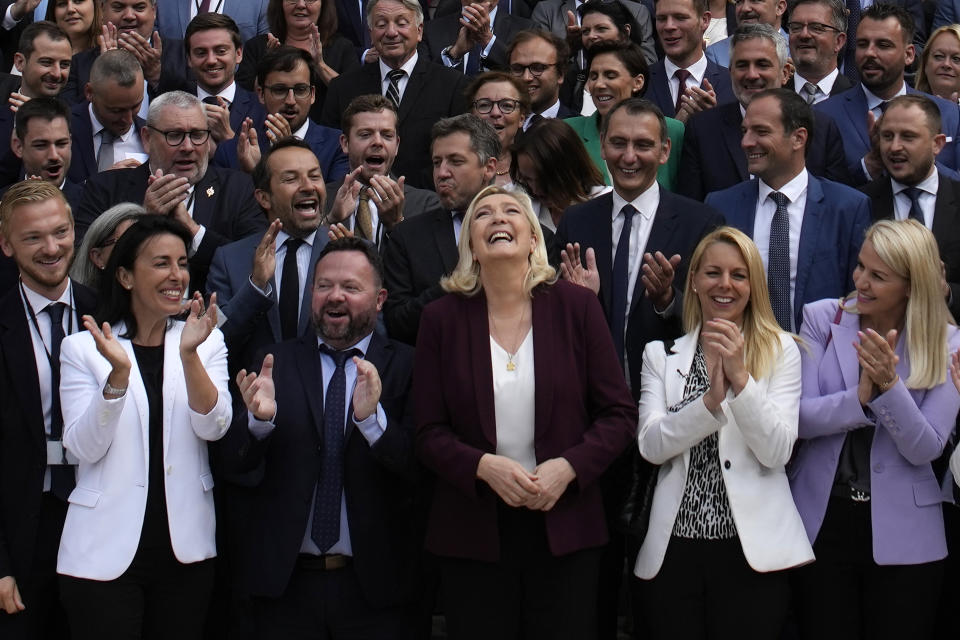 French far-right leader Marine Le Pen, center, and National Rally party newly elected parliament members pose at the National Assembly Wednesday, June 22, 2022 in Paris. This was the year war returned to Europe, and few facets of life were left untouched. Russia’s invasion of its neighbor Ukraine unleashed misery on millions of Ukrainians, shattered Europe’s sense of security, ripped up the geopolitical map and rocked the global economy. The shockwaves made life more expensive in homes across Europe, worsened a global migrant crisis and complicated the world’s response to climate change. (AP Photo/Christophe Ena)