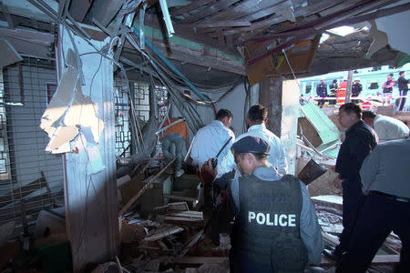 Officials inspect the damage after a bomb blast in Lashio, Myanmar February 21, 2018 in this picture obtained from social media. Ministry of Information Webportal Myanmar/via REUTERS