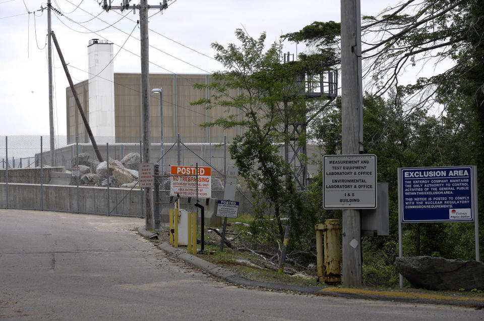 FILE - Warning signs are posted near a gate to the Pilgrim Nuclear Power Station, in Plymouth, Mass., Tuesday, May 28, 2019. Pilgrim, which closed in 2019, was a boiling water reactor. Water constantly circulated through the reactor vessel and nuclear fuel, converting it to steam to spin the turbine. The water was cooled and recirculated, picking up radioactive contamination. (AP Photo/Steven Senne, File)