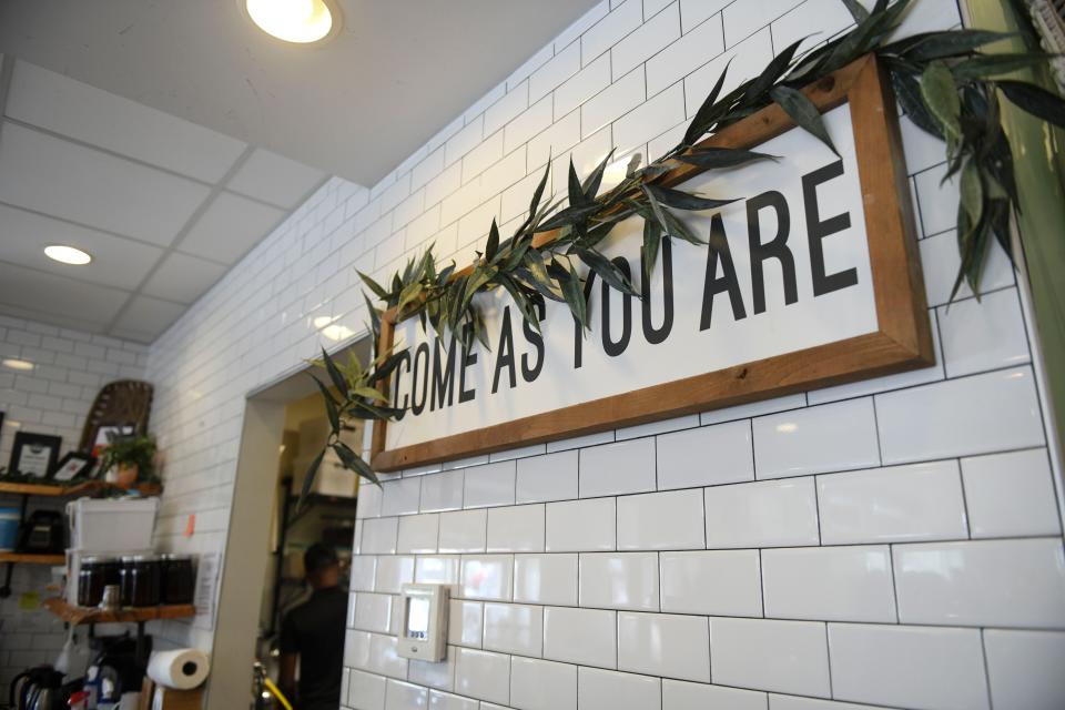 A sign reading "Come as you are" hangs in Rooted Coffeehouse in Evans, Ga., on Wednesday, Sept. 13, 2023.