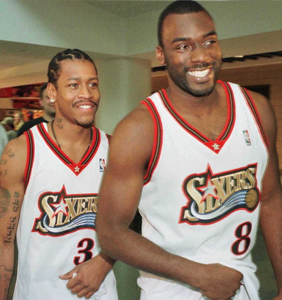 FILE - In this Oct. 4, 1999, file photo, Philadelphia 76ers' Allen Iverson (3) and teammate Aaron McKie (8) smile as they enter an NBA basketball news conference during the team's media day in Philadelphia. McKie is just the third head coach for Temple since Hall of Famer John Chaney was hired in 1982. (AP Photo/William Thomas Cain, File)