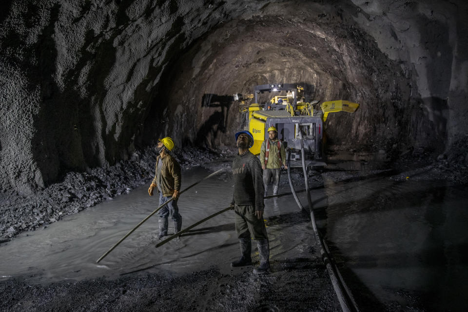 Workers employed by the Megha Engineering And Infrastructures Limited (MEIL) work inside the Nilgrar Tunnel in Baltal area, northeast of Srinagar, Indian controlled Kashmir, Tuesday, Sept. 28, 2021. High in a rocky Himalayan mountain range, hundreds of people are working on an ambitious project to drill tunnels and construct bridges to connect the Kashmir Valley with Ladakh, a cold-desert region isolated half the year because of massive snowfall. The $932 million project’s last tunnel, about 14 kilometers (9 miles) long, will bypass the challenging Zojila pass and connect Sonamarg with Ladakh. Officials say it will be India’s longest and highest tunnel at 11,500 feet (3,485 meters). (AP Photo/Dar Yasin)