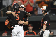 Baltimore Orioles' Jorge Mateo, left, is embraced by Ramon Urias after hitting a three-run home run against the Boston Red Sox during the second inning of a baseball game Friday, Aug. 19, 2022, in Baltimore. (AP Photo/Gail Burton)