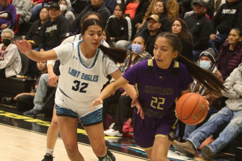 Kirtland Central's Teghan Begay (22) looks to get inside Navajo Prep's Layla Harrison (32) in the first quarter of a girls basketball game, Tuesday, Dec. 20, 2022 at the Eagles Nest.