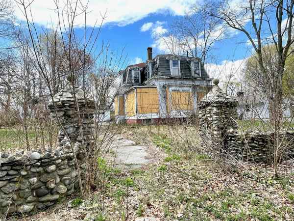 The former historic but rundown and neglected home at 212 Woodbury Ave. was demolished to make way for a new high-end Chinburg housing development.