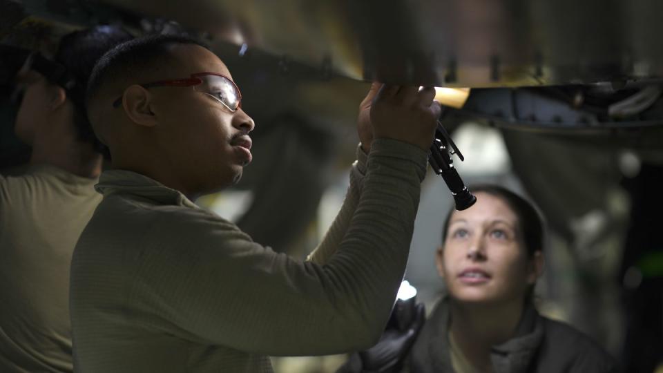 Maintainers work on an F-15E at RAF Lakenheath, England, in 2019. The Air Force wants to smooth the transition from tech school to operational units. (Senior Airman Malcolm Mayfield/Air Force)