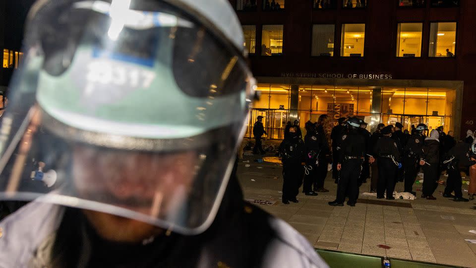 NYPD officers block off an encampment set up by pro-Palestinian students and protesters on the campus of New York University (NYU) to protest the Israel-Hamas war as other officers detain the remaining protesters and clear the camp, in New York on April 22. - Alex Kent/AFP/Getty Images