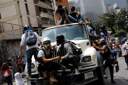 Demonstrators stand on a truck during a rally against President Nicolas Maduro in Caracas, Venezuela, May 24, 2017. REUTERS/Carlos Garcia Rawlins