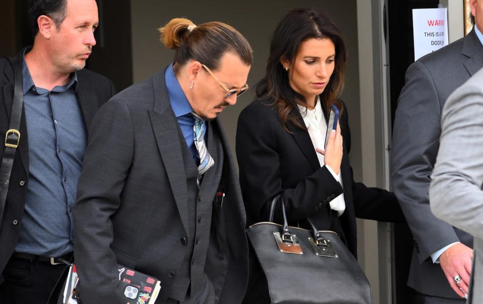 Johnny Depp place and Joelle Rich leave Fairfax County Courthouse in May 2022 - Splash News
