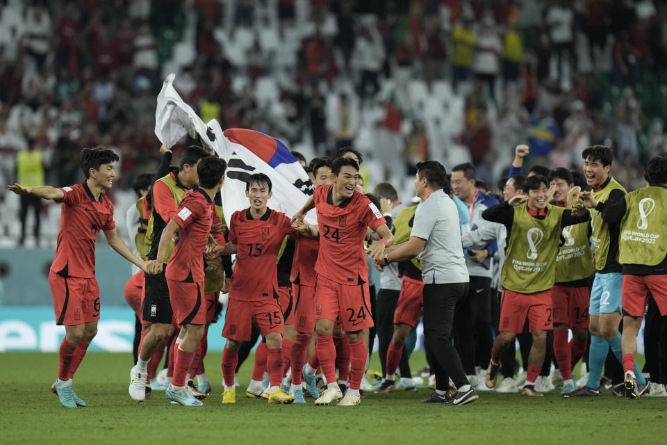 South Korea's players celebrate at the end of the World Cup group H soccer match between South Korea and Portugal, at the Education City Stadium in Al Rayyan , Qatar, Friday, Dec. 2, 2022. (AP Photo/Hassan Ammar)