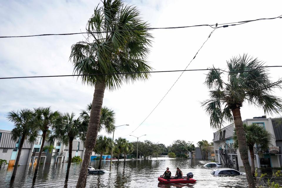 A water rescue boat moves in flood waters at an apartment complex on Thursday morning in Clearwater, Florida. ((AP Photo/Mike Stewart))