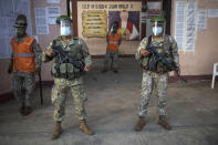 Soldiers stand guard outside a school during a COVID-19 vaccination campaign for the elderly in Iquitos, Peru, Thursday, March 18, 2021. (AP Photo/Rodrigo Abd)