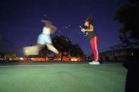 Jada Riley blows bubbles on a basketball court to entertain her 6-year-old son Jayden Harris, Thursday, July 28, 2022, near her former apartment in New Orleans. “I've slept outside for a whole year before. It's very depressing, I'm not going to lie,” said Riley, who often doesn't have enough money to buy gas or afford food every day. “I don't want to have my son experience any struggles that I went through.” (AP Photo/Gerald Herbert)