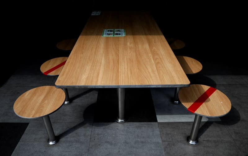 Tables are taped up to encourage social distancing, due to the outbreak of the coronavirus disease (COVID-19), at a food center in Singapore