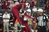 Arizona Cardinals tight end Trey McBride (85) celebrates his touchdown with offensive tackle Paris Johnson Jr. (70) during the second half of an NFL football game against the Baltimore Ravens Sunday, Oct. 29, 2023, in Glendale, Ariz. (AP Photo/Rick Scuteri)