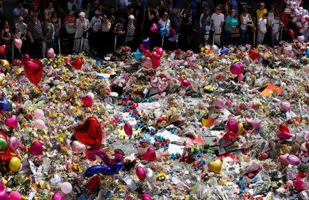 People look at floral tributes for the victims of the Manchester Arena attack, in St Ann's Square, in central Manchester, Britain May 27, 2017. REUTERS/Stefan Wermuth
