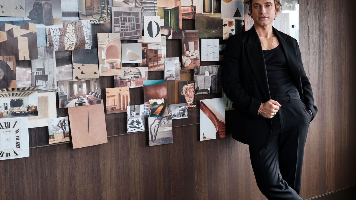 jeremiah brent standing in front of a wall of photos