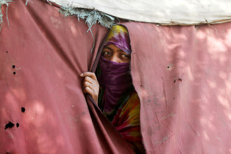 FILE PHOTO: A woman displaced from the Red Sea port city of Hodeidah looks from a tent shelter in Sanaa, Yemen November 28, 2018. Picture taken November 28, 2018. REUTERS/Mohamed al-Sayaghi/File Photo