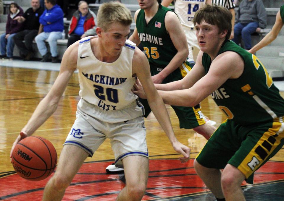 Mackinaw City's Noah Valot (left) posts up on Engadine’s Luke Germaine during a recent non-conference matchup for the Comets.