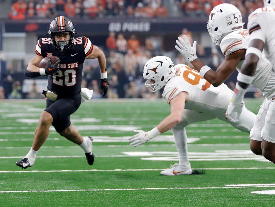 Oklahoma State's Sesi Vailahi (20) rushes in the first half of the Big 12 Football Championship game between the Oklahoma State University Cowboys and the Texas Longhorns at the AT&T Stadium in Arlington, Texas, Saturday, Dec. 2, 2023.