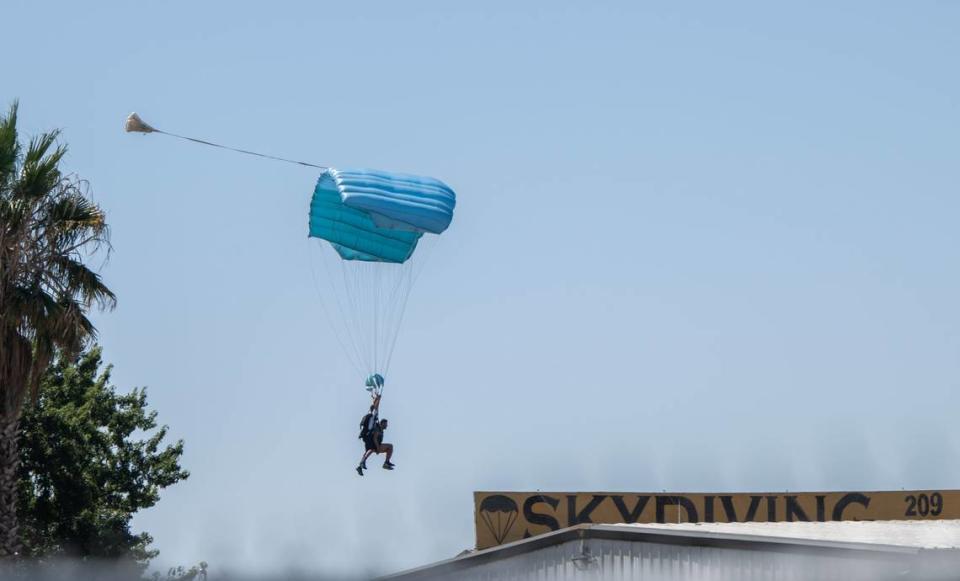 Tandem skydivers land at the Parachute Center in September.