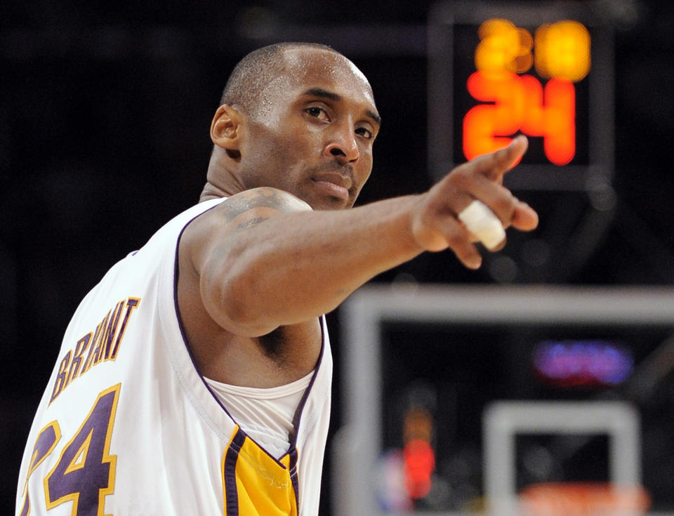 FILE - In this June 7, 2009, file photo, Los Angeles Lakers guard Kobe Bryant (24) points to a player behind him after making a basket in the closing seconds against the Orlando Magic in Game 2 of the NBA basketball finals in Los Angeles. Federal investigators said Wednesday, June 17, 2020, that the pilot of the helicopter that crashed in thick fog, killing Kobe Bryant and seven other passengers, reported he was climbing when he actually was descending. (AP Photo/Mark J. Terrill, File)