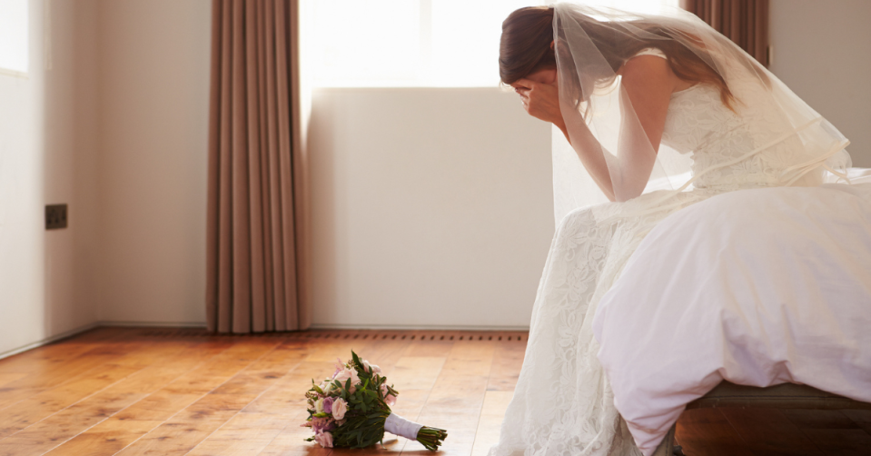 Bride with head in her hands 