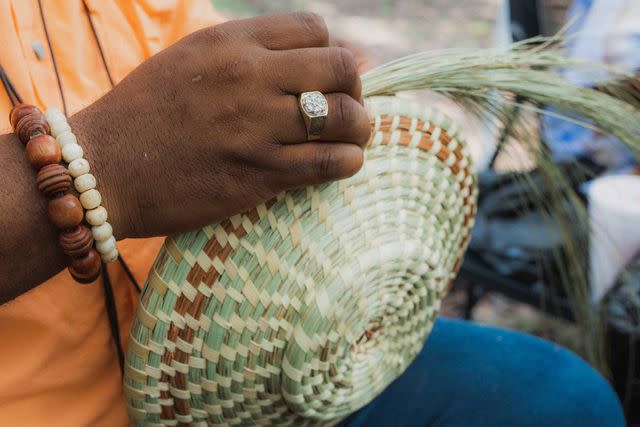 <p>Courtesy of Hilton Head Island VCB</p> Craftsman Michael Smalls weaves a sweetgrass basket.