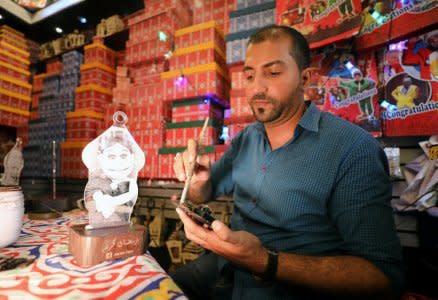 Mohamed Gamal works on a lantern with a portrait of Abla Fahita, a puppet television host, in Cairo, Egypt May 16, 2017.  REUTERS/Mohamed Abd El Ghany