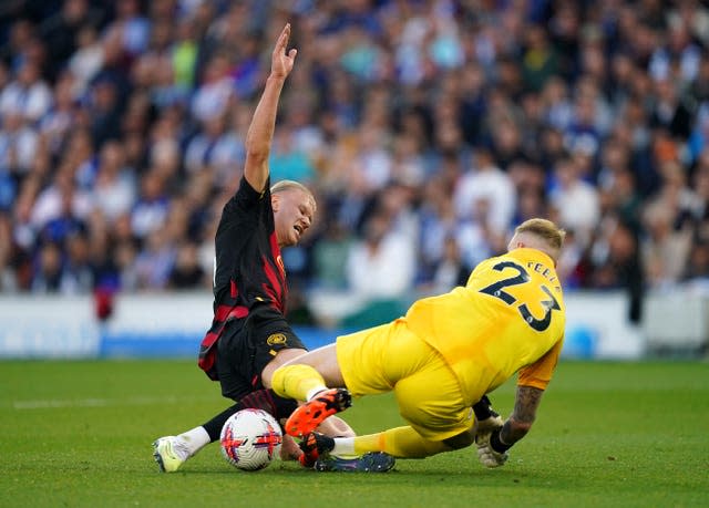 Jason Steele makes a save at the feet of Erling Haaland