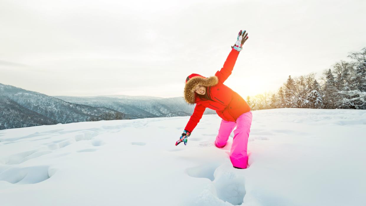  Woman walking through the deep snow. 