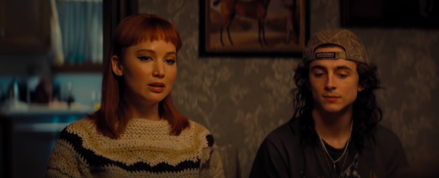 A woman and man sit side by side at the dinner table