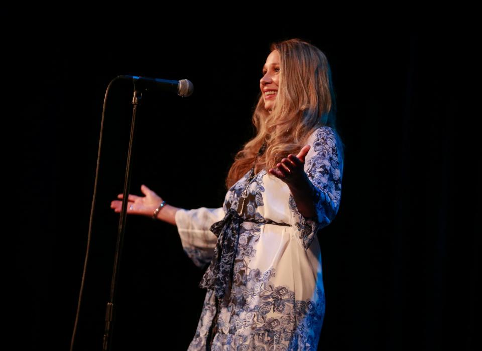 Brenda McGuire shares her story of traveling around the world during the Des Moines Register's Storytellers Project at Hoyt Sherman Place on Tuesday, June 14, 2022.