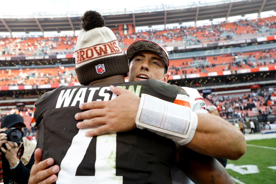 Cleveland Browns quarterback Deshaun Watson (4) hugs Arizona Cardinals quarterback Clayton Tune (15) after the teams' game Sunday in Cleveland.