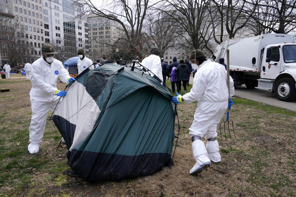 Workers clear a homeless encampment at McPherson Square in Washington, Wednesday, Feb. 15, 2023. (AP Photo/Patrick Semansky)