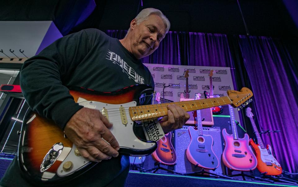 Musician Mike Beaber, of the band Timeline, tests a Fender Stratocaster guitar at Total Music Source in Cape Coral.