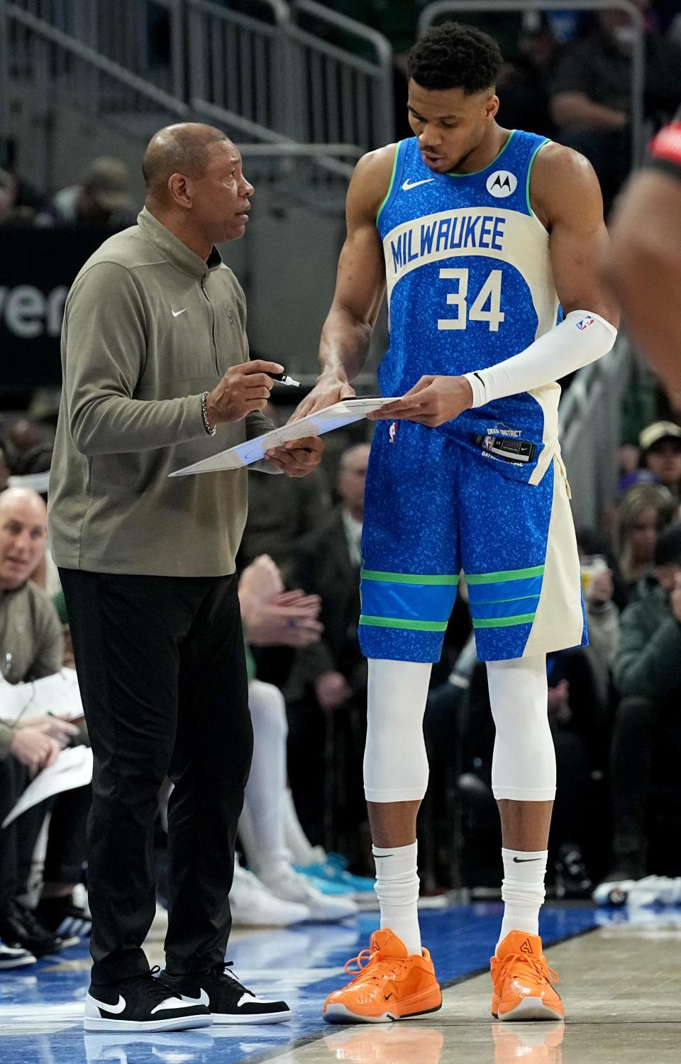 Bucks head coach Doc Rivers talks with forward Giannis Antetokounmpo during a game in March. Having a training camp and season together should help them.